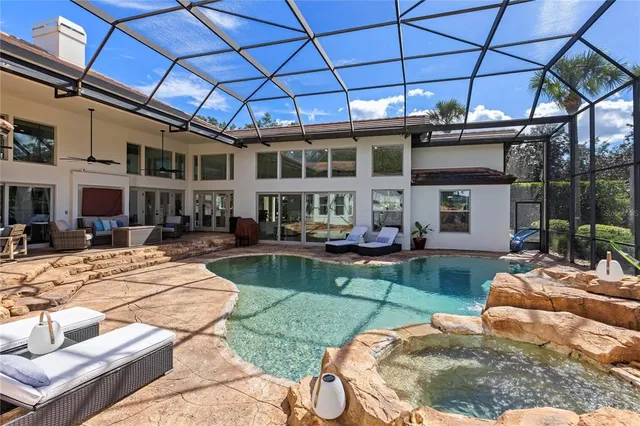 a view of a house with backyard porch and sitting area