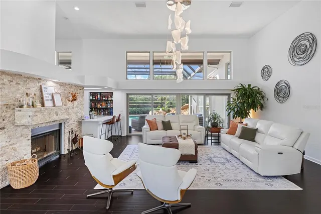 a living room with furniture a fireplace and a table