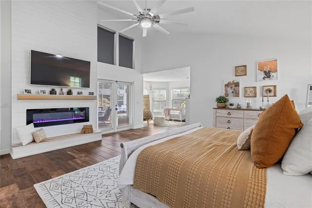 a spacious bedroom with a bed and a flat screen tv