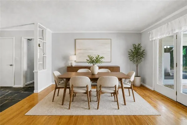 a view of a dining room with furniture and wooden floor