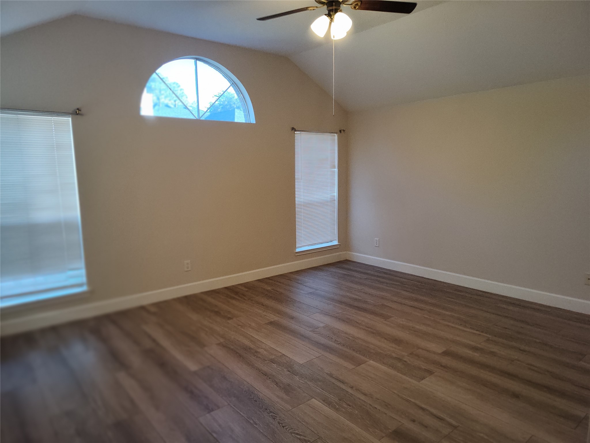 4127 North Nolan Place Pearland, TX 77584 - Photo 11 of 25 an empty room with wooden floor fan and windows