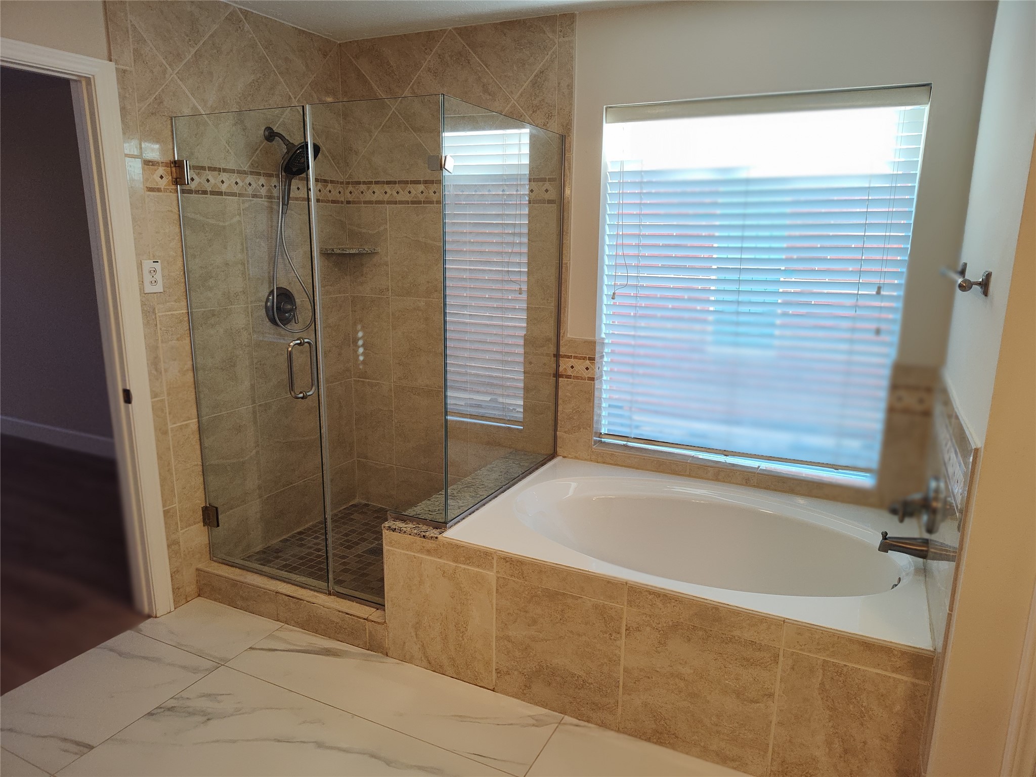 4127 North Nolan Place Pearland, TX 77584 - Photo 13 of 25 a bathroom with a shower and a bathtub