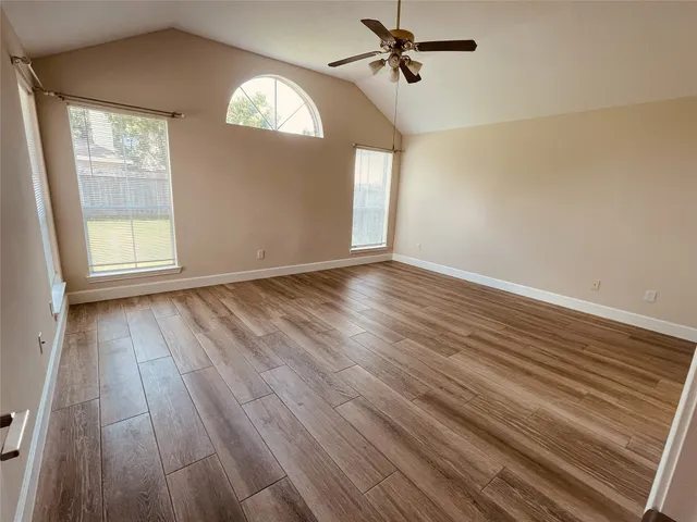 wooden floor in an empty room with a window