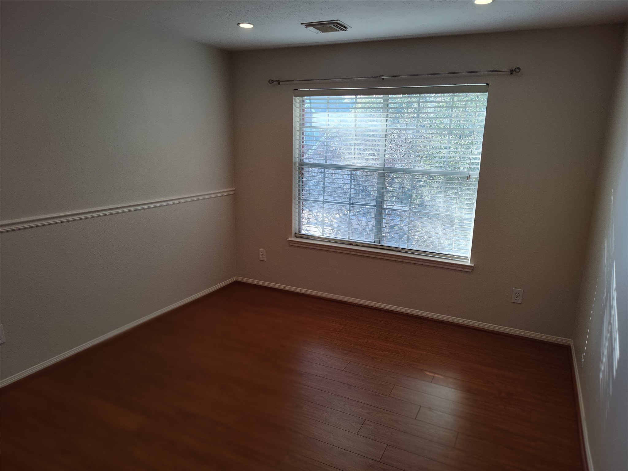 4127 North Nolan Place Pearland, TX 77584 - Photo 18 of 25 an empty room with wooden floor and windows