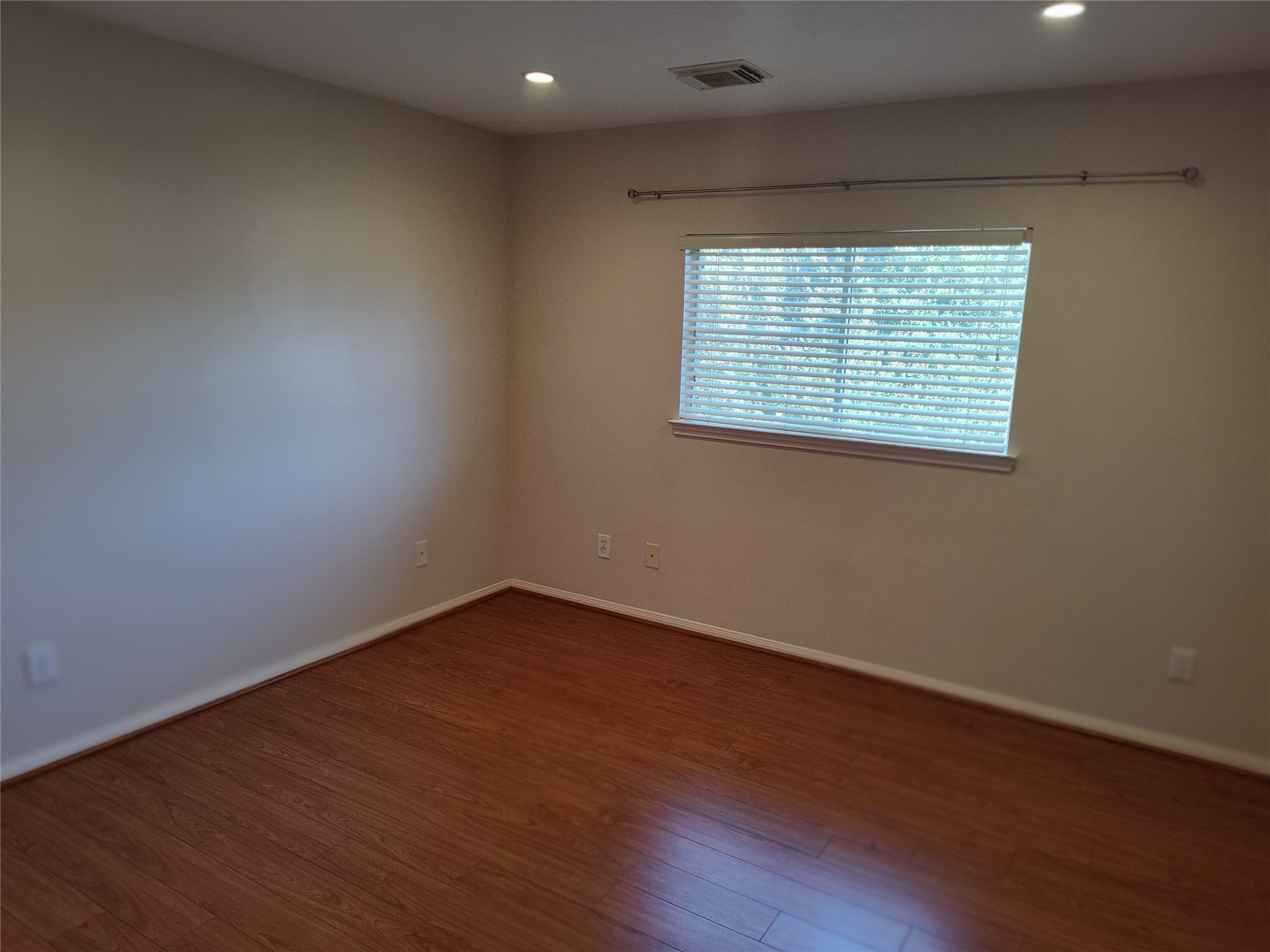 4127 North Nolan Place Pearland, TX 77584 - Photo 22 of 25 an empty room with wooden floor and a window