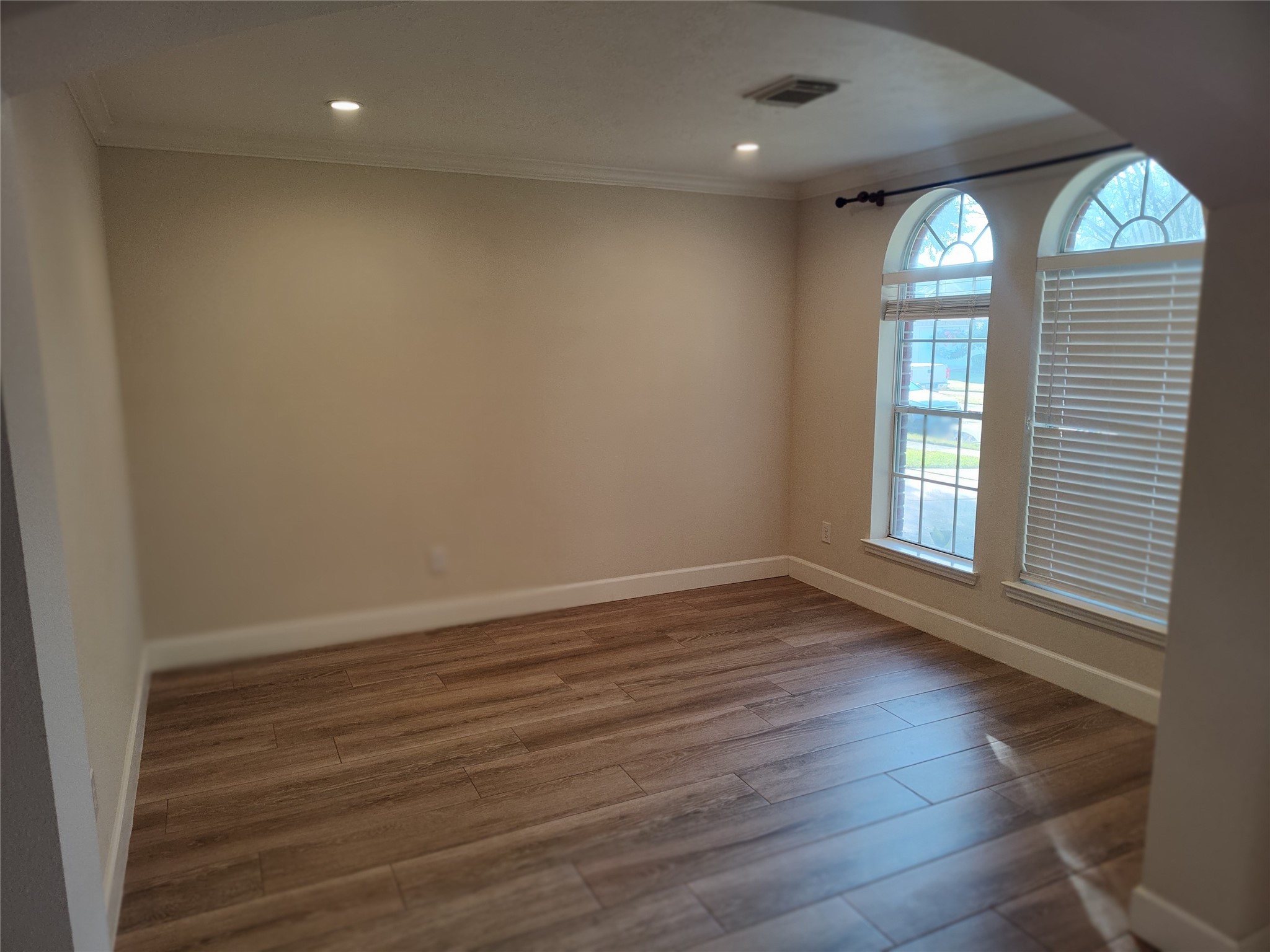 4127 North Nolan Place Pearland, TX 77584 - Photo 3 of 25 an empty room with wooden floor and windows
