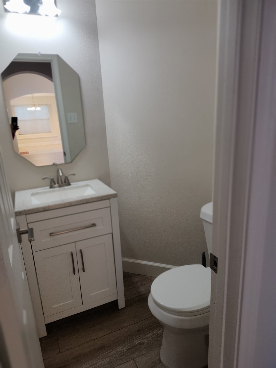4127 North Nolan Place Pearland, TX 77584 - Photo 10 of 25 a bathroom with a toilet sink and mirror