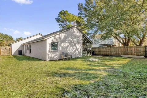 a backyard of a house with table and chairs