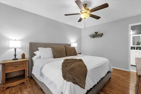 a bedroom with bed and a chandelier