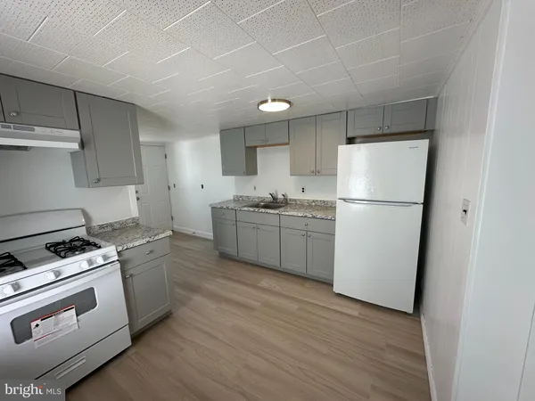 a kitchen with a white cabinets and white appliances