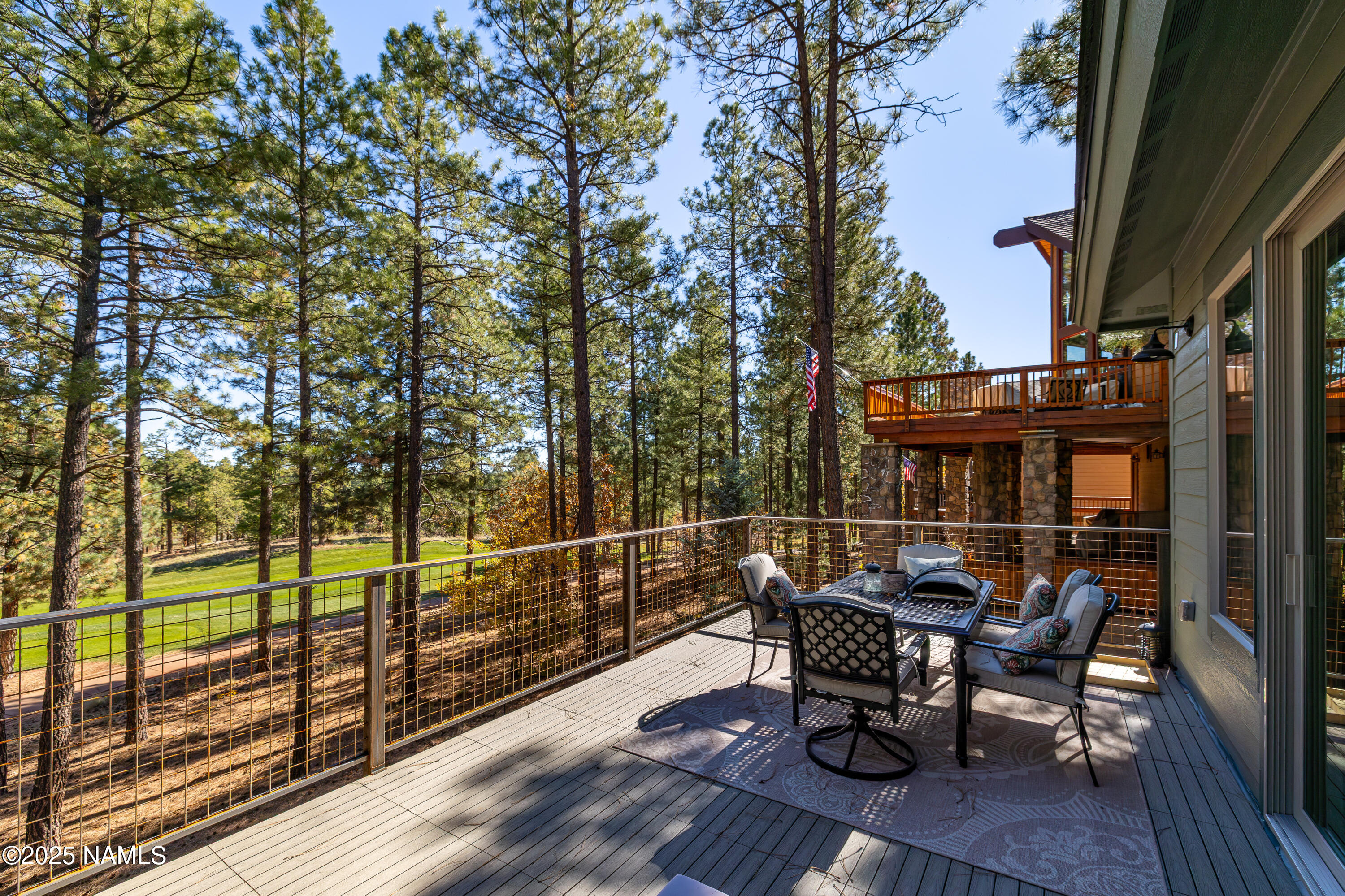4180 Lariat Loop Flagstaff, AZ 86005 - Photo 18 of 59 a view of a roof deck with table and chairs and wooden floor