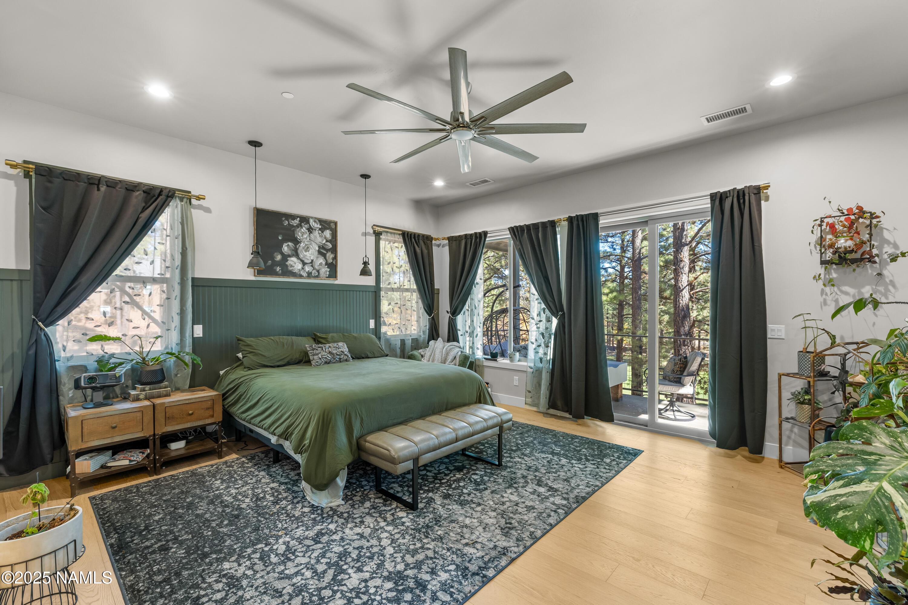 4180 Lariat Loop Flagstaff, AZ 86005 - Photo 23 of 59 a bedroom with a bed and large window with outer view
