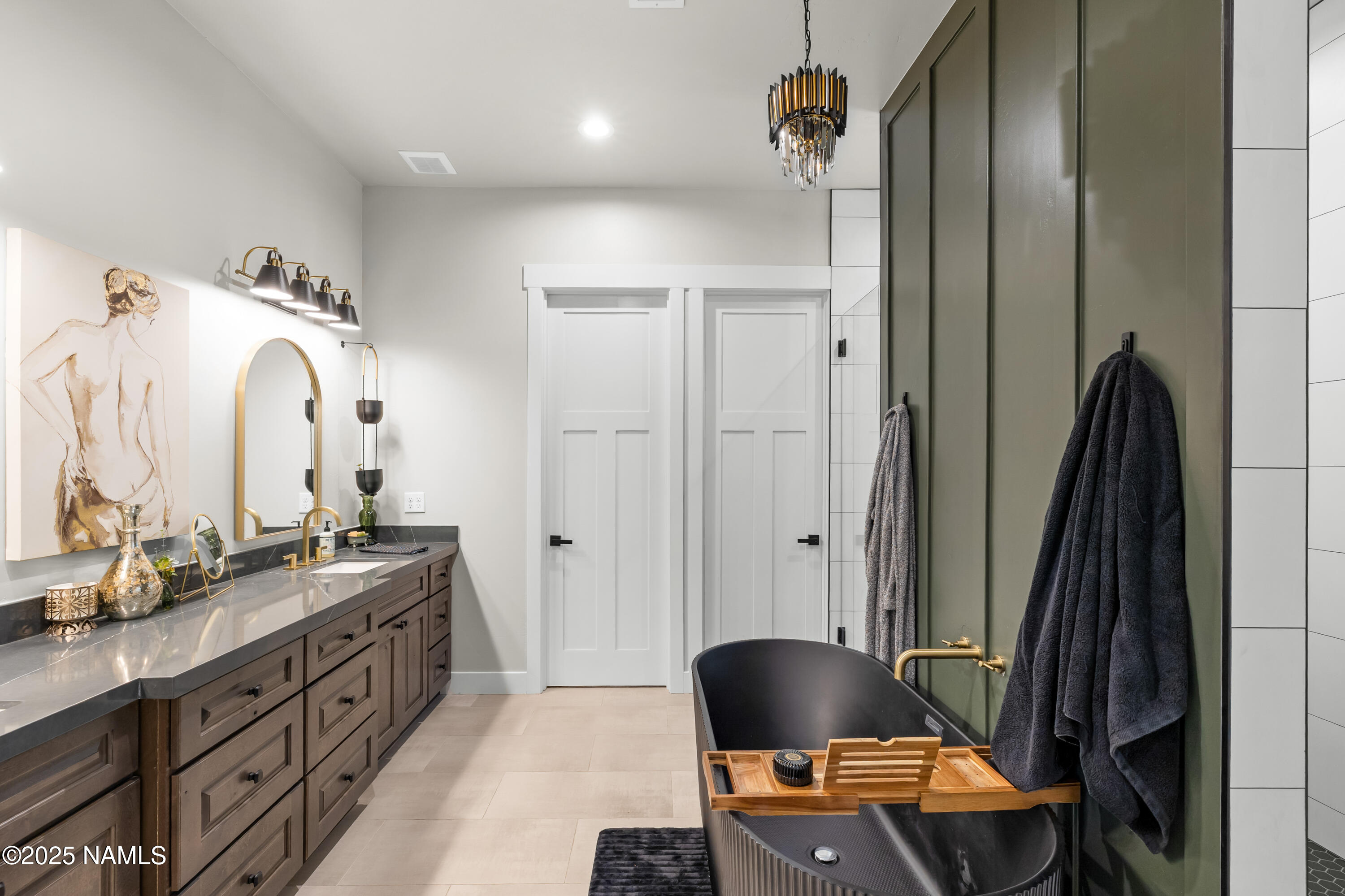 4180 Lariat Loop Flagstaff, AZ 86005 - Photo 25 of 59 a view of a bathroom with a sink a mirror and a shower