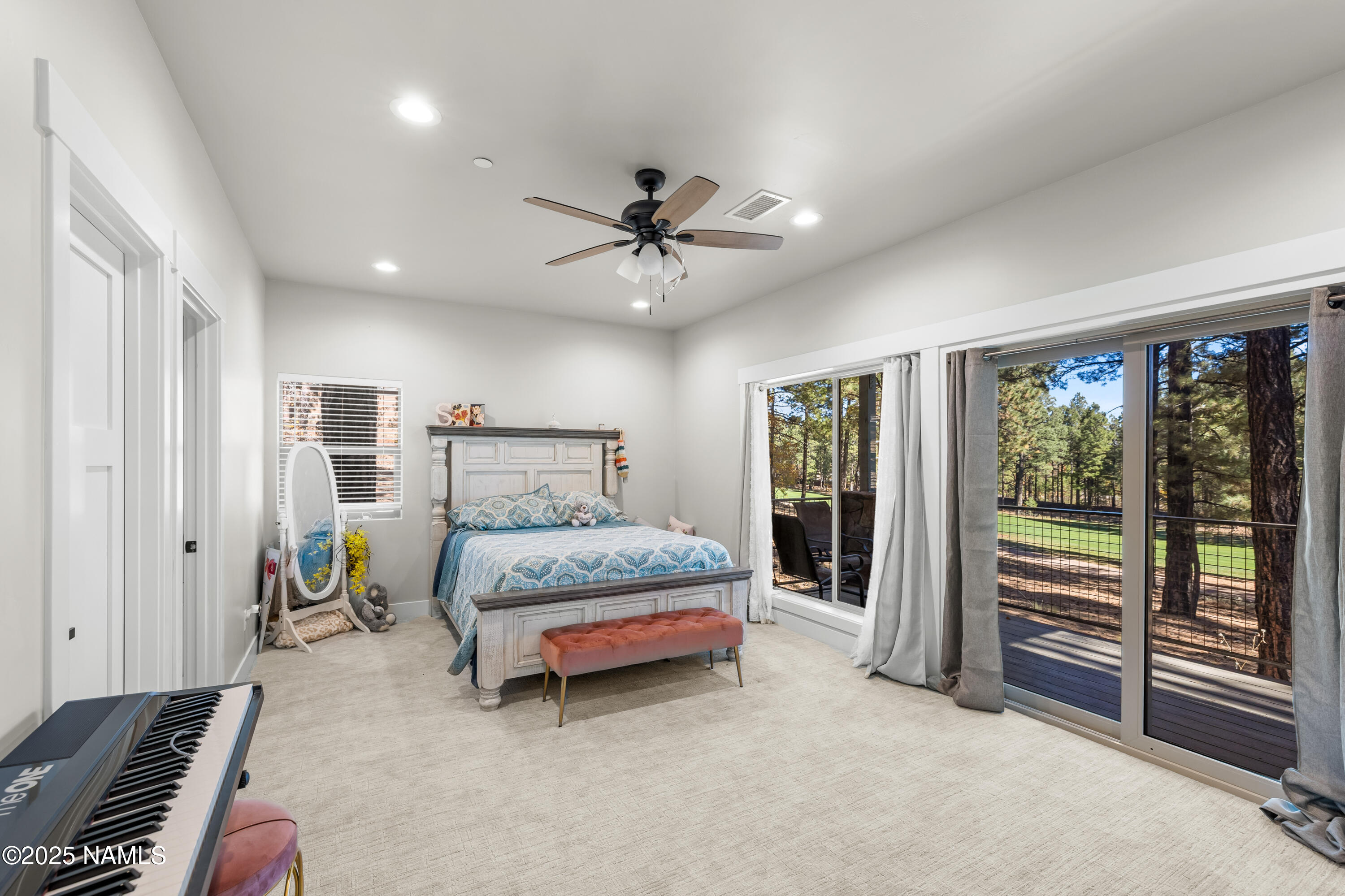 4180 Lariat Loop Flagstaff, AZ 86005 - Photo 35 of 59 a spacious bedroom with a bed and a chandelier