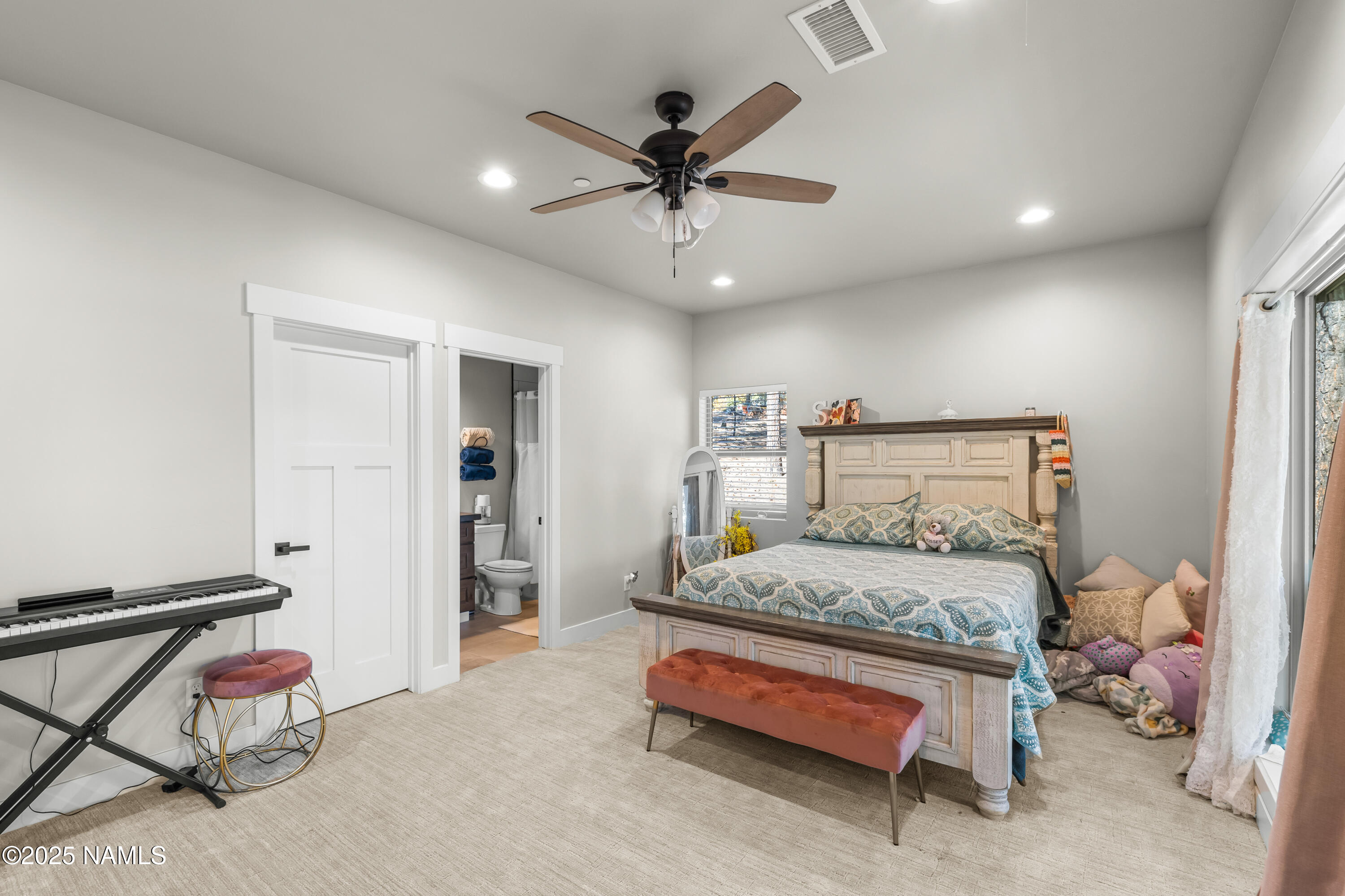 4180 Lariat Loop Flagstaff, AZ 86005 - Photo 36 of 59 a bedroom with a bed and a ceiling fan