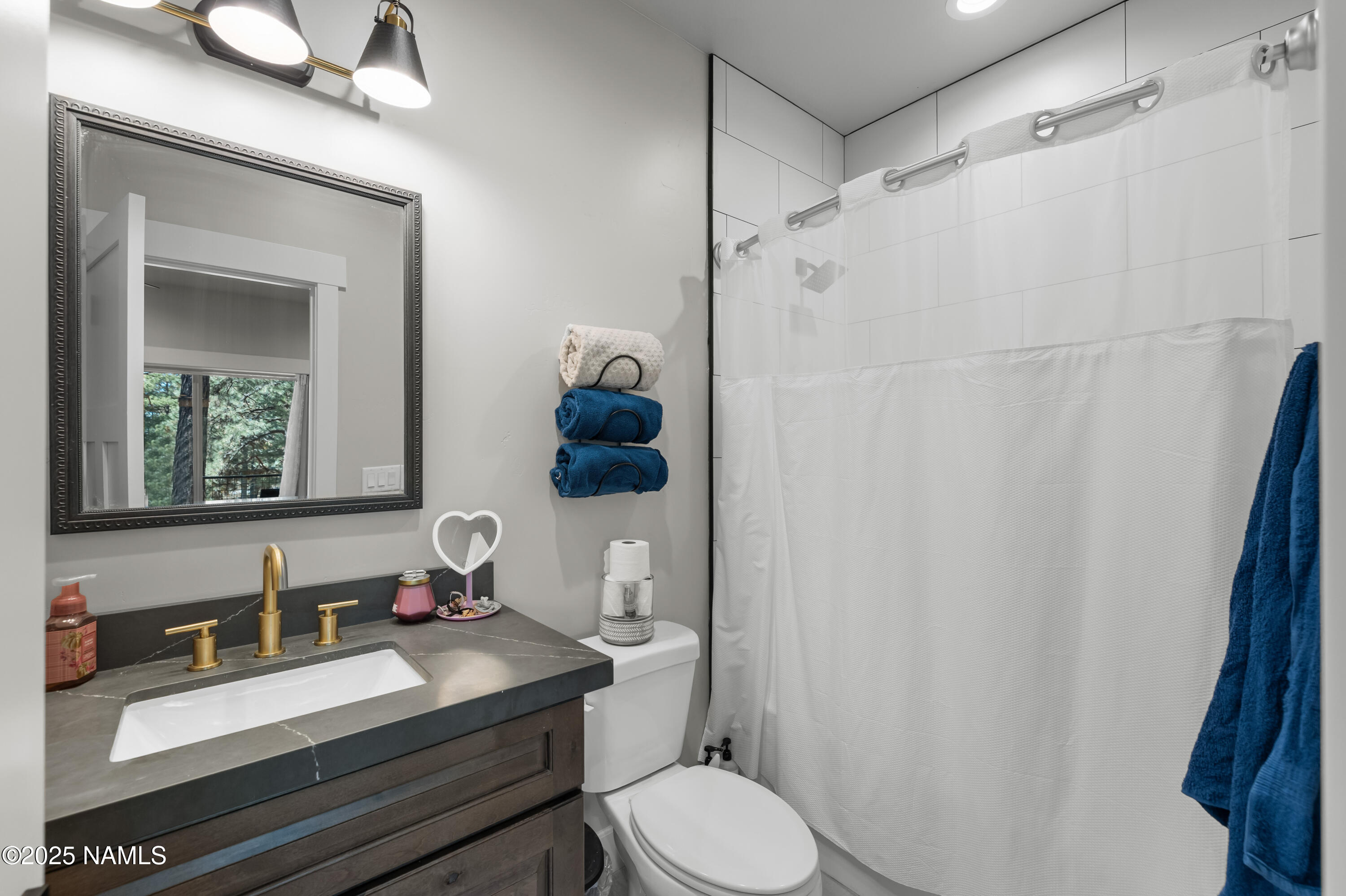 4180 Lariat Loop Flagstaff, AZ 86005 - Photo 38 of 59 a bathroom with a sink toilet and shower