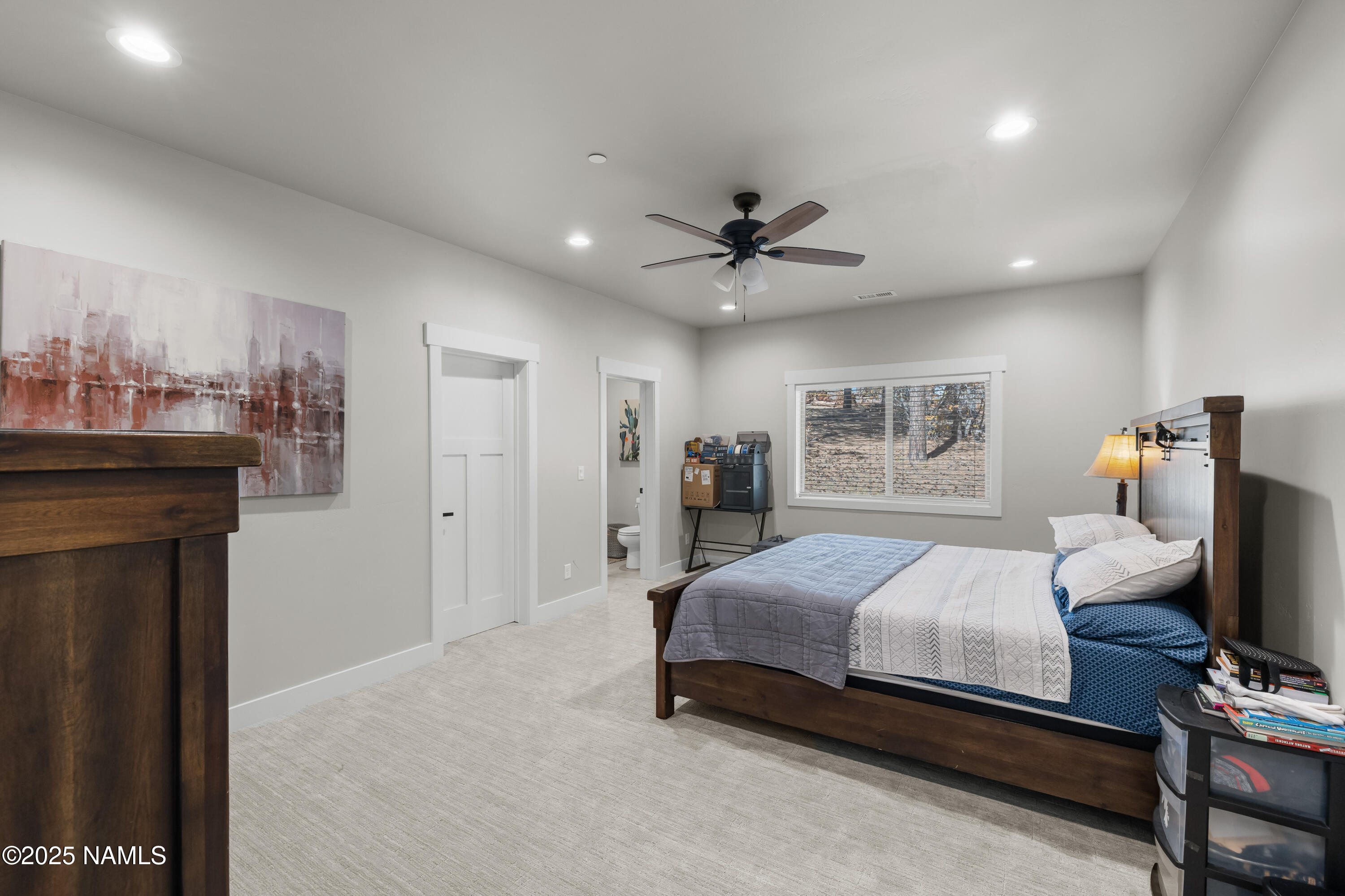 4180 Lariat Loop Flagstaff, AZ 86005 - Photo 40 of 59 a bedroom with a bed and a chandelier