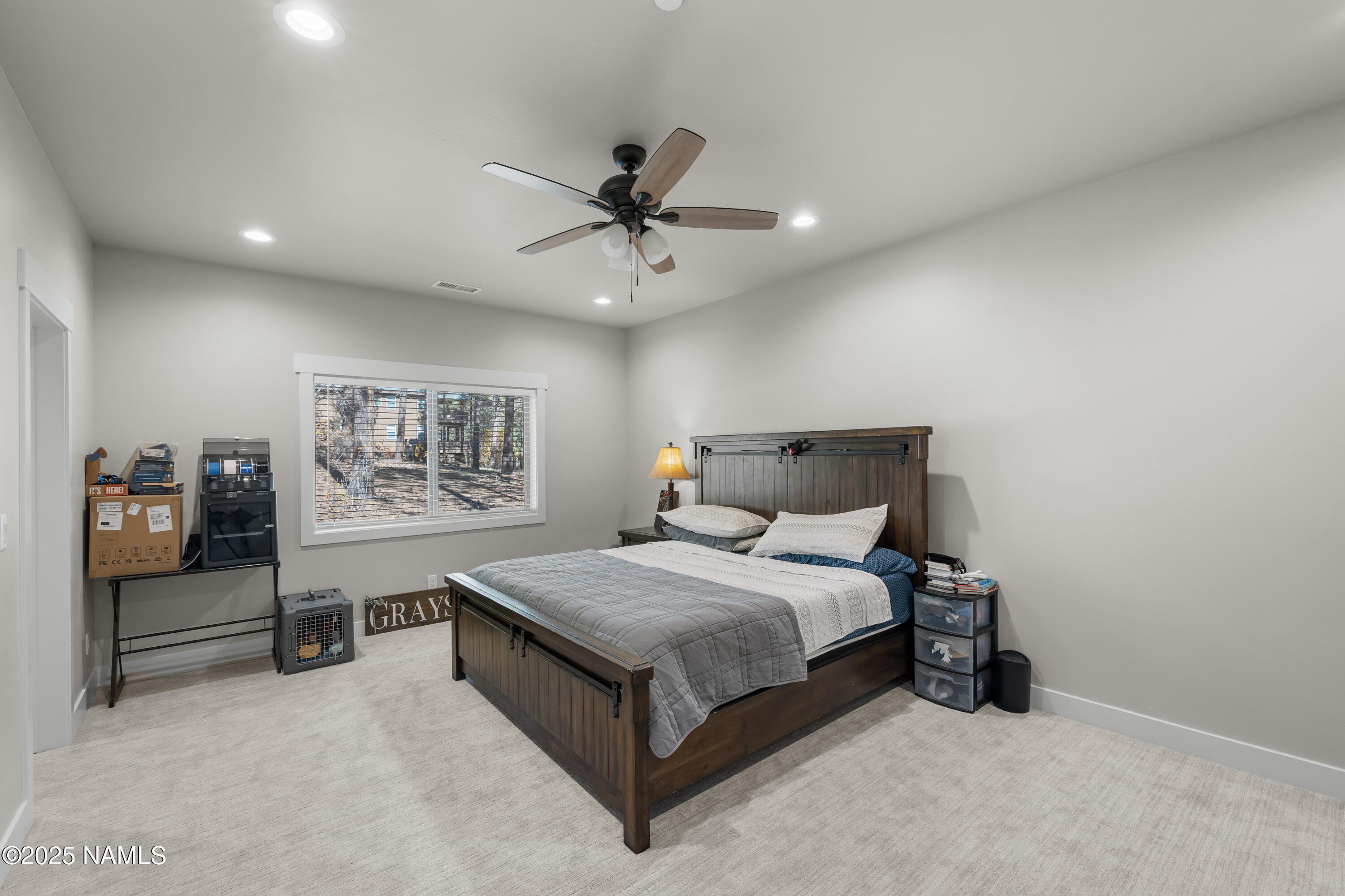 4180 Lariat Loop Flagstaff, AZ 86005 - Photo 41 of 59 a bedroom with a bed and a chandelier