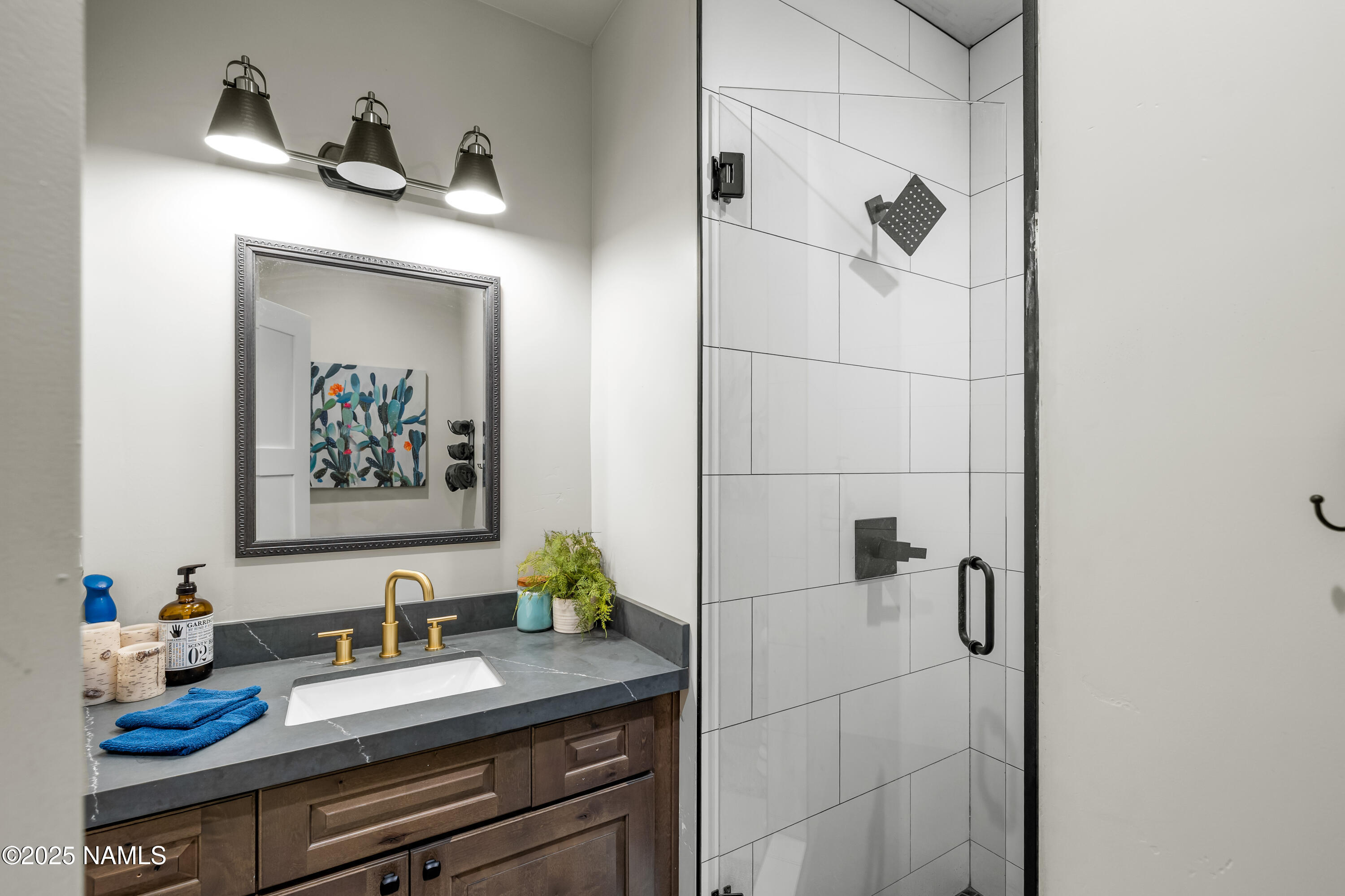 4180 Lariat Loop Flagstaff, AZ 86005 - Photo 43 of 59 a bathroom with a granite countertop sink a mirror and shower