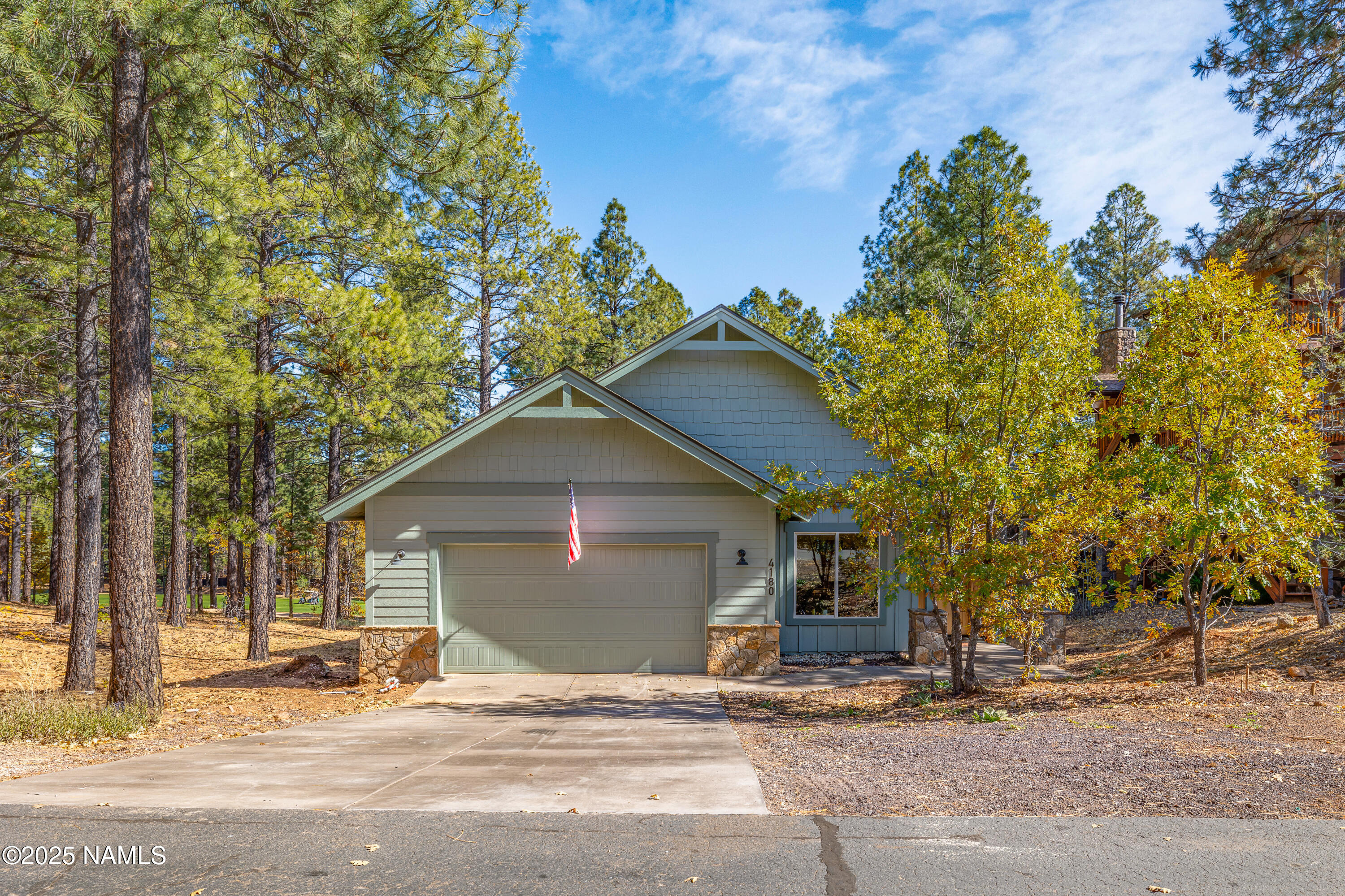 4180 Lariat Loop Flagstaff, AZ 86005 - Photo 45 of 59 a front view of a house with a yard and garage