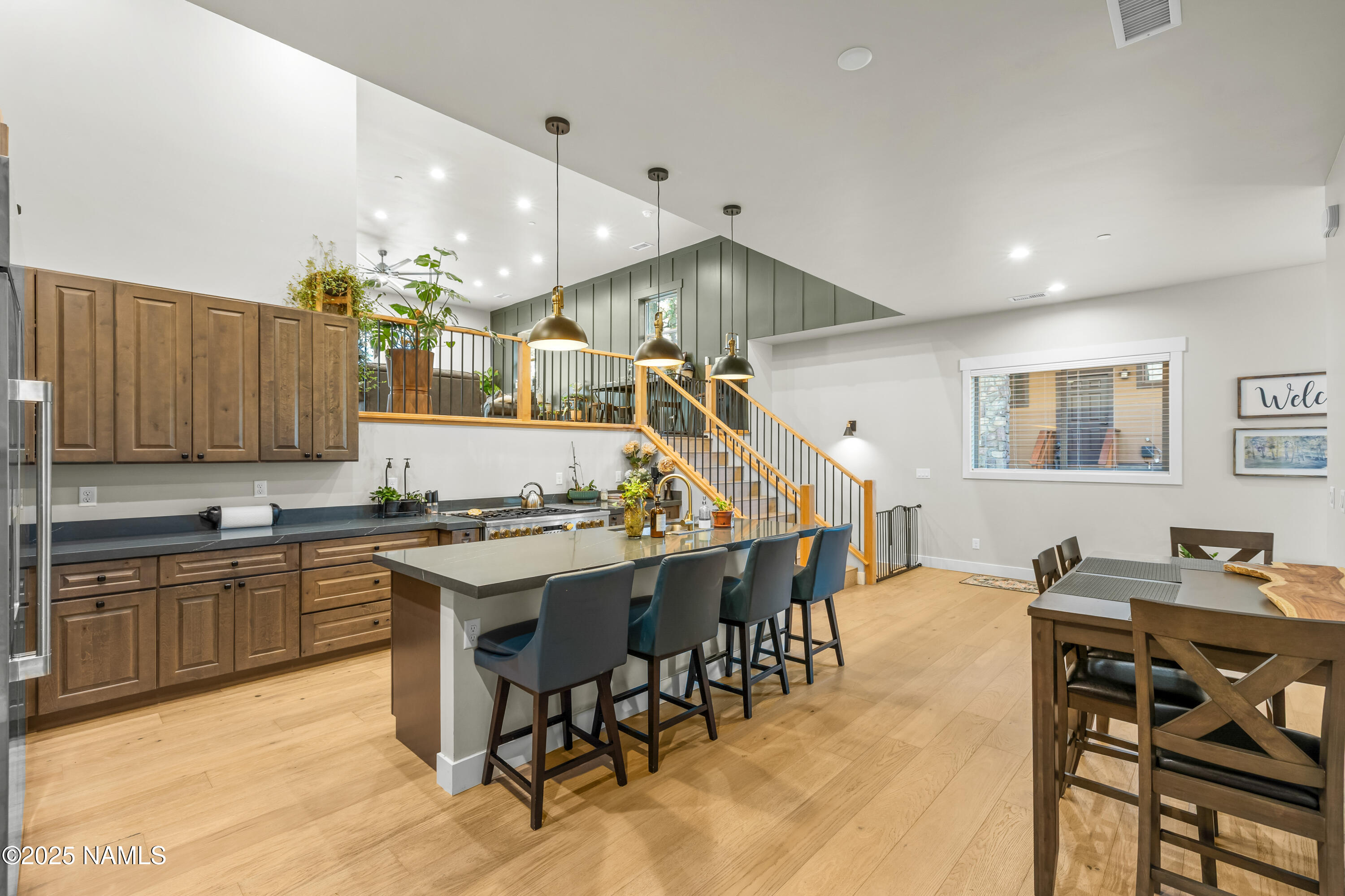 4180 Lariat Loop Flagstaff, AZ 86005 - Photo 5 of 59 a kitchen with stainless steel appliances kitchen island granite countertop a table chairs sink and cabinets