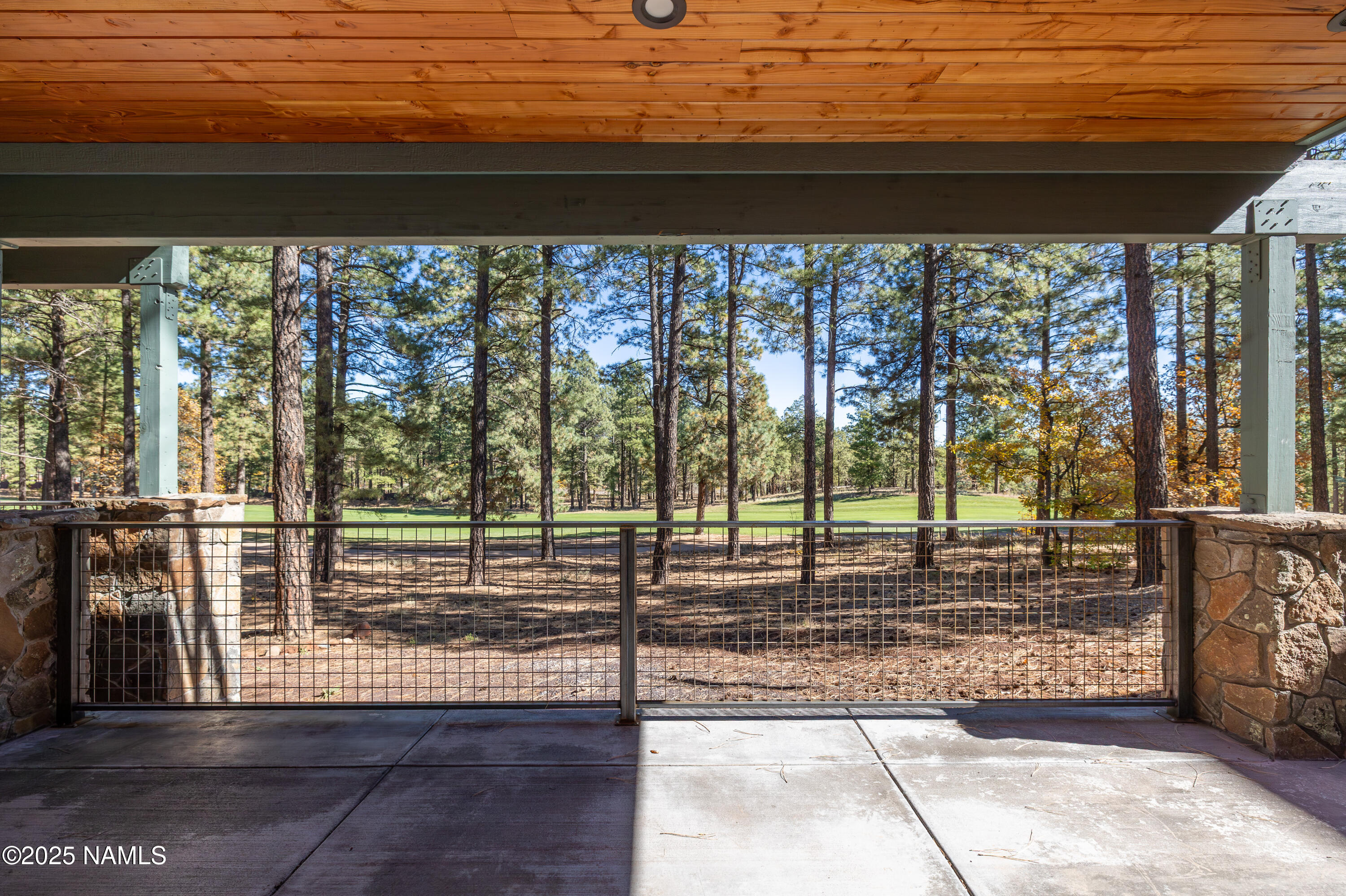 4180 Lariat Loop Flagstaff, AZ 86005 - Photo 53 of 59 a view of empty room with wooden floor and floor to ceiling window