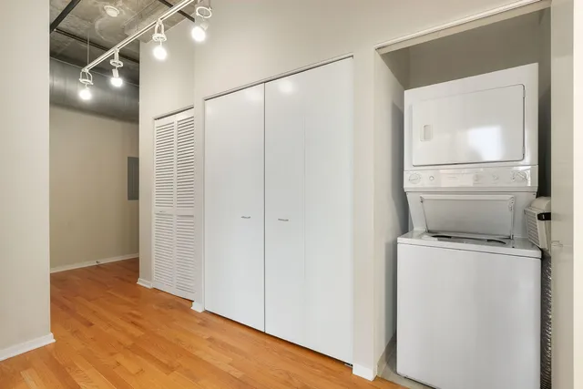 a view of storage and utility room with wooden floor