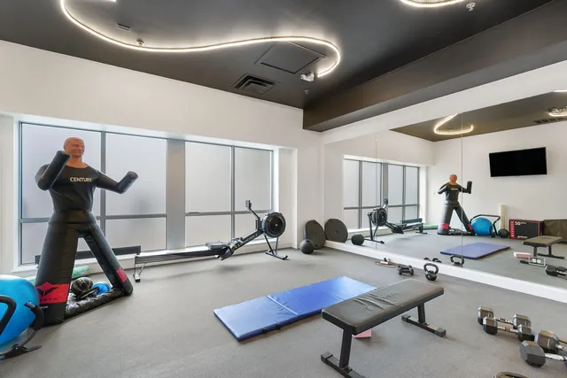 a room with gym equipment and a table