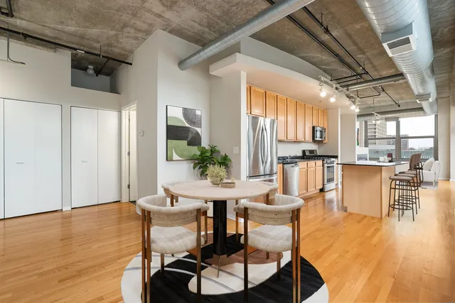 a view of a dining room with furniture and wooden floor