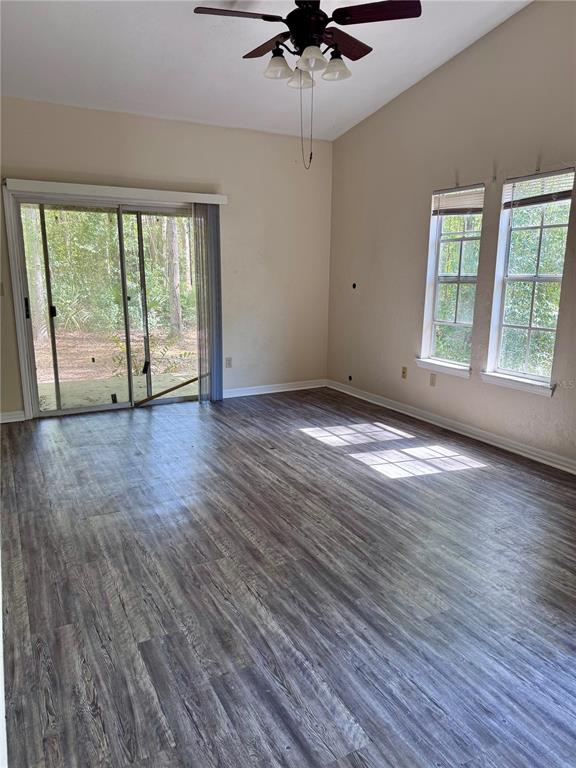 329 Northwest 48th Boulevard Gainesville, FL 32607 - Photo 2 of 7 a view of an empty room with wooden floor and a window