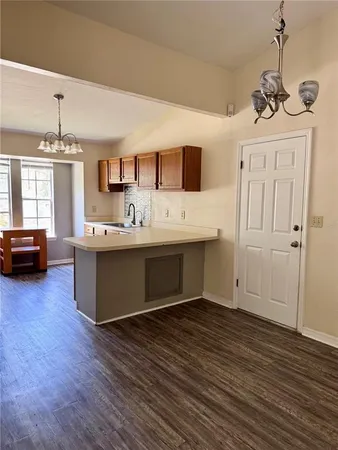a living room with a bed furniture flat screen tv and a window