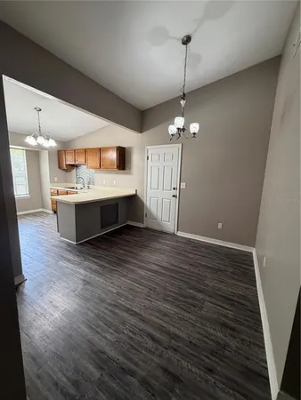 a living room with hard wood floors and a ceiling fan