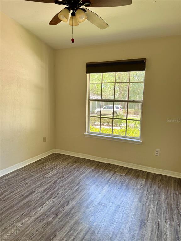 329 Northwest 48th Boulevard Gainesville, FL 32607 - Photo 6 of 7 wooden floor in an empty room with a window