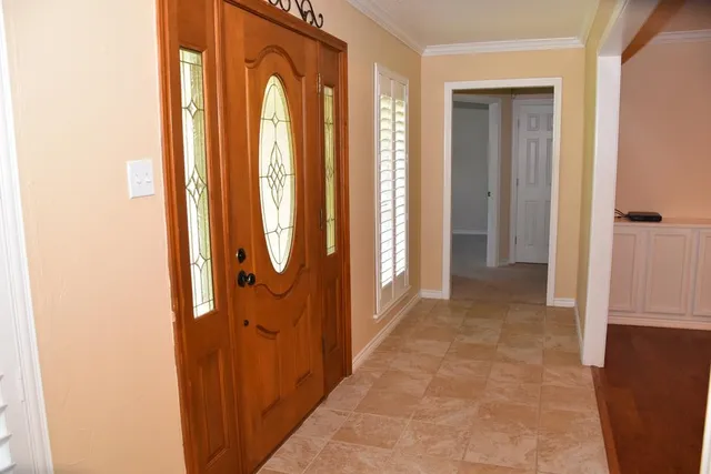 a view of a hallway with windows and closet