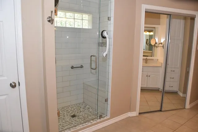 a bathroom with a glass shower door and a bathroom
