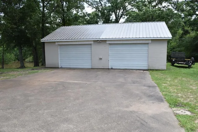 a front view of a house with garage and yard