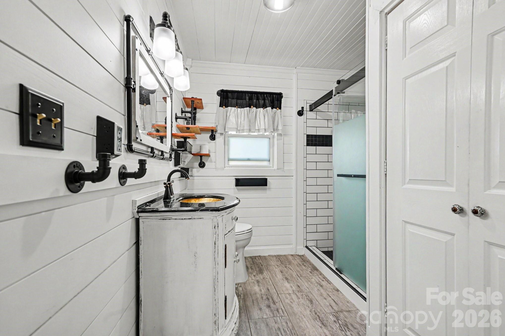 24359 Ridgecrest Road Locust, NC 28097 - Photo 13 of 26 a hallway with white cabinets and washer