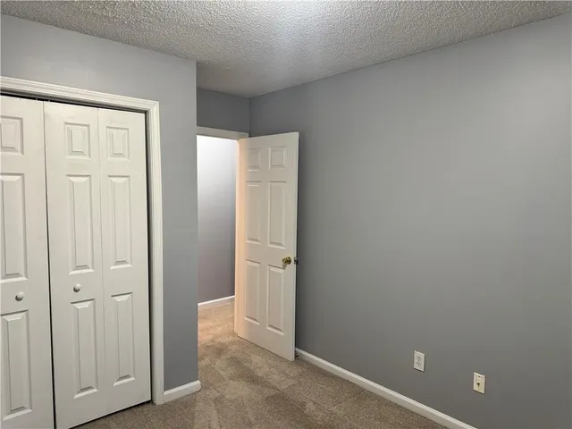 an empty room with closet area