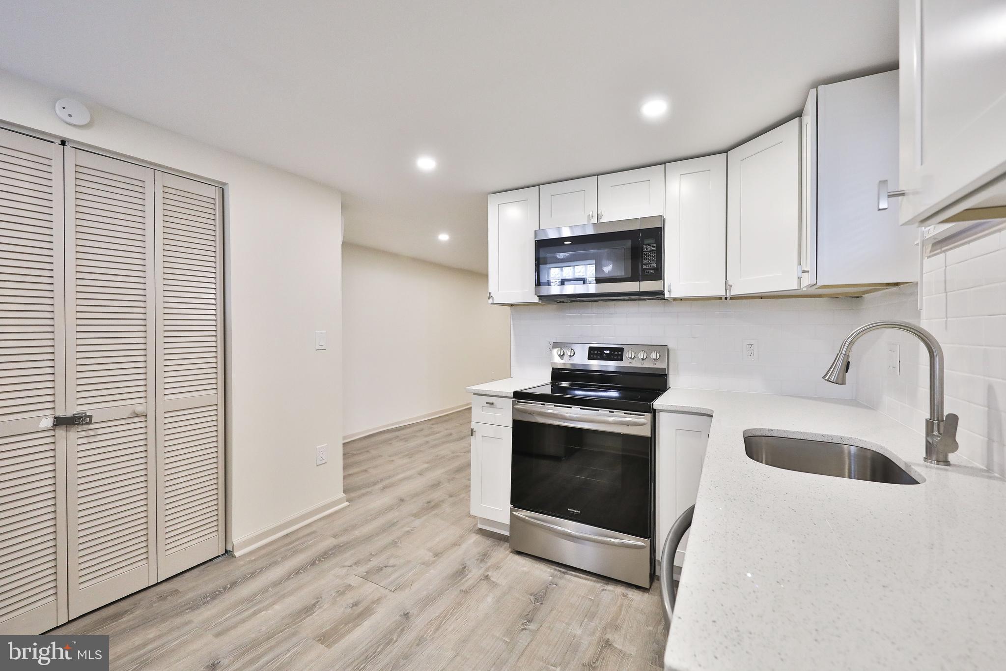 314 Huntingdon Pike, Unit 314A Jenkintown, PA 19046 - Photo 5 of 14 a kitchen with stainless steel appliances granite countertop a stove a sink and a microwave