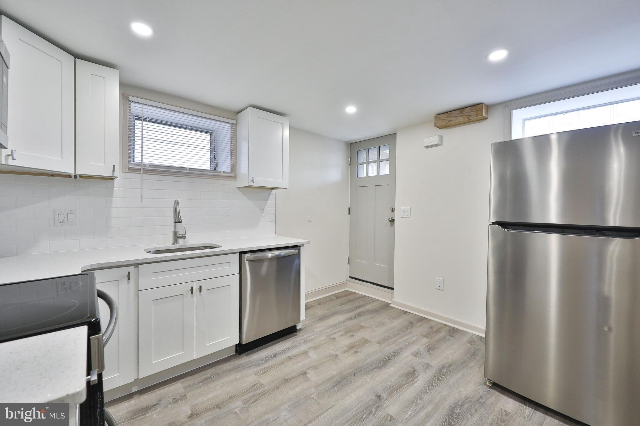 314 Huntingdon Pike, Unit 314A Jenkintown, PA 19046 - Photo 6 of 14 a kitchen with a refrigerator a sink and cabinets