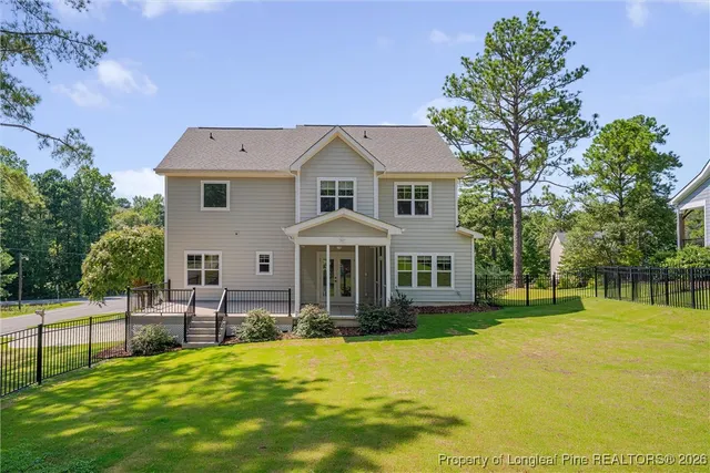 a front view of house with yard and green space