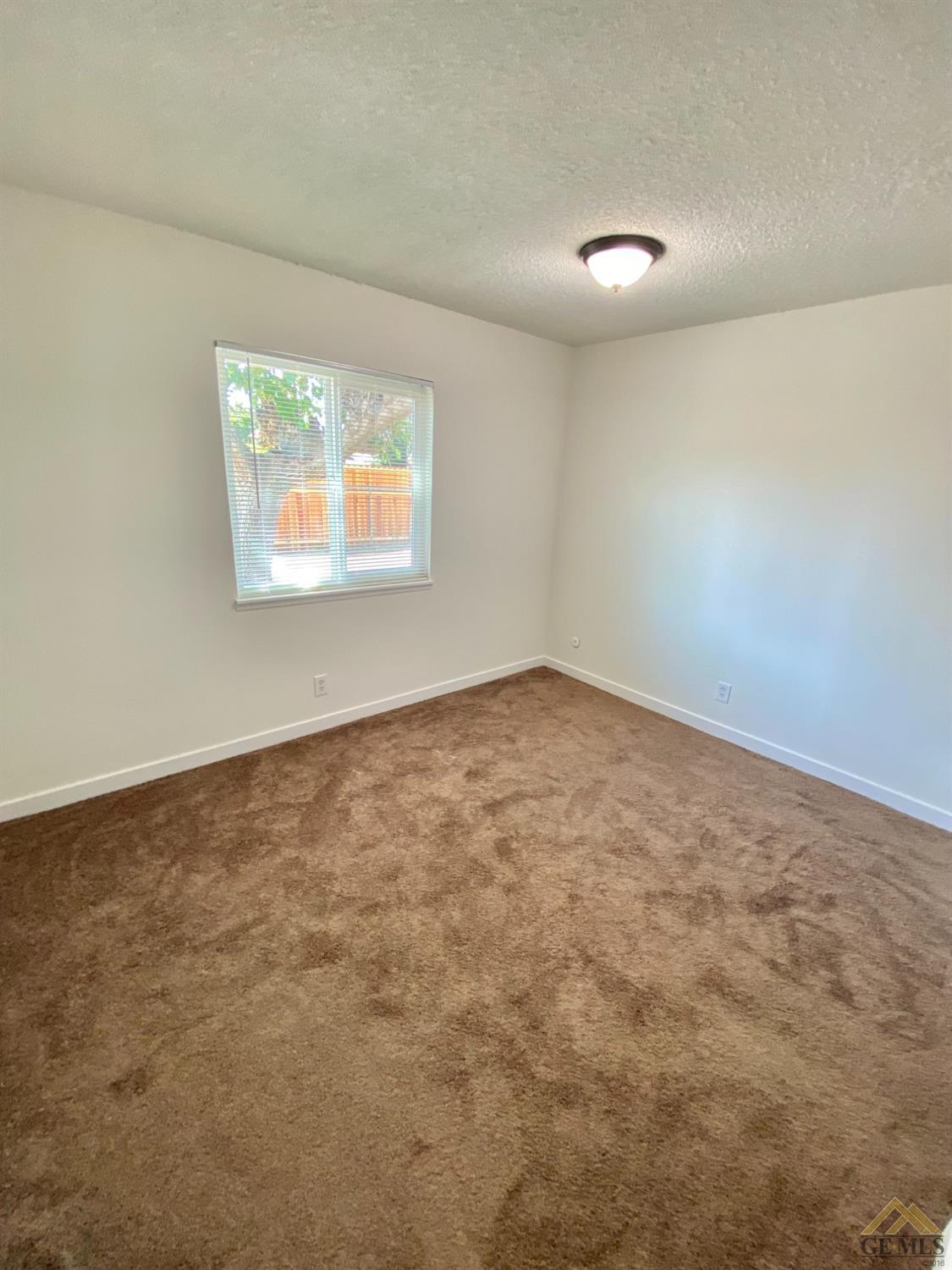 Undisclosed Address Wasco, CA 93280 - Photo 7 of 10 an empty room with windows