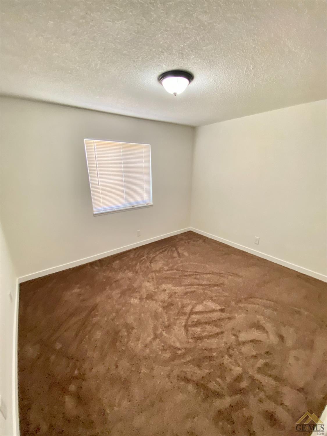 Undisclosed Address Wasco, CA 93280 - Photo 8 of 10 en empty room with windows