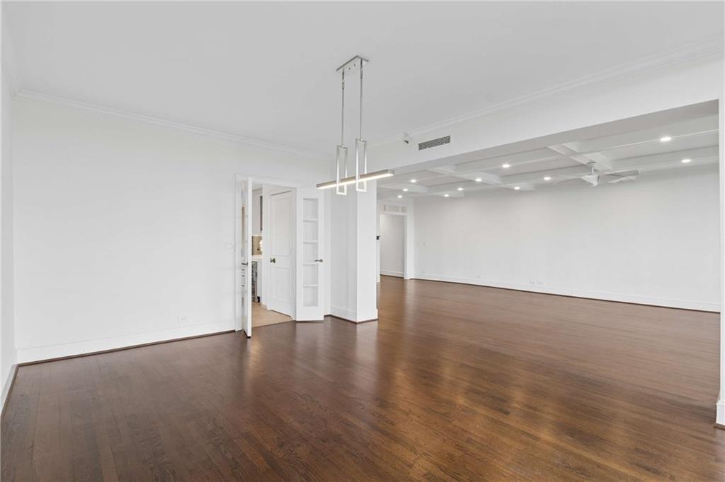 2660 Peachtree Road Northwest, Unit 13F Atlanta, GA 30305 - Photo 18 of 56 a view of a room with wooden floor and a ceiling fan