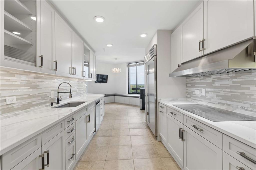 2660 Peachtree Road Northwest, Unit 13F Atlanta, GA 30305 - Photo 24 of 56 a large white kitchen with a sink and dishwasher