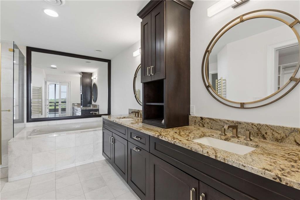 2660 Peachtree Road Northwest, Unit 13F Atlanta, GA 30305 - Photo 31 of 56 a bathroom with a granite countertop double vanity sink and a mirror