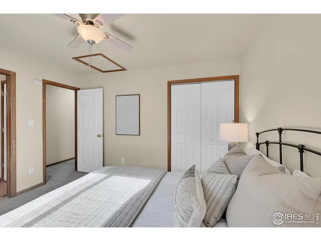 a bedroom with a bed and a mirror