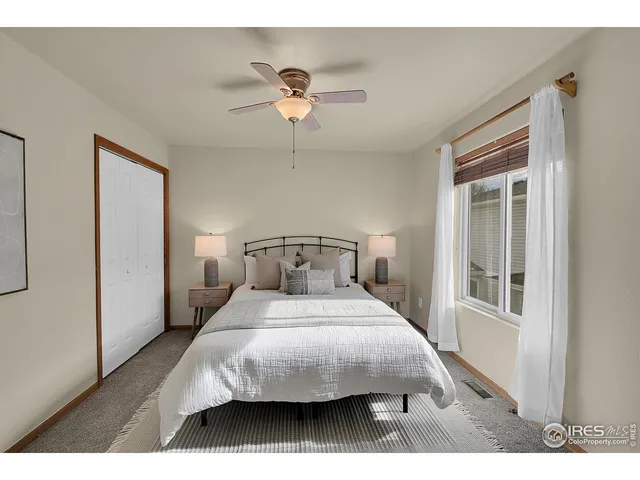 a bedroom with a bed and a night stand