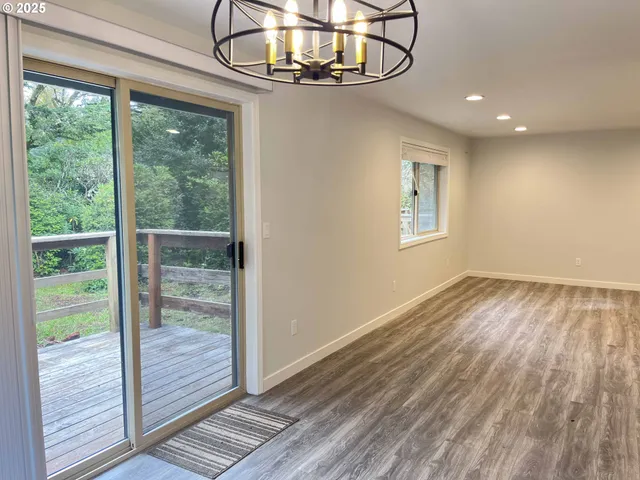 a view of a kitchen with a sink wooden floor and a window