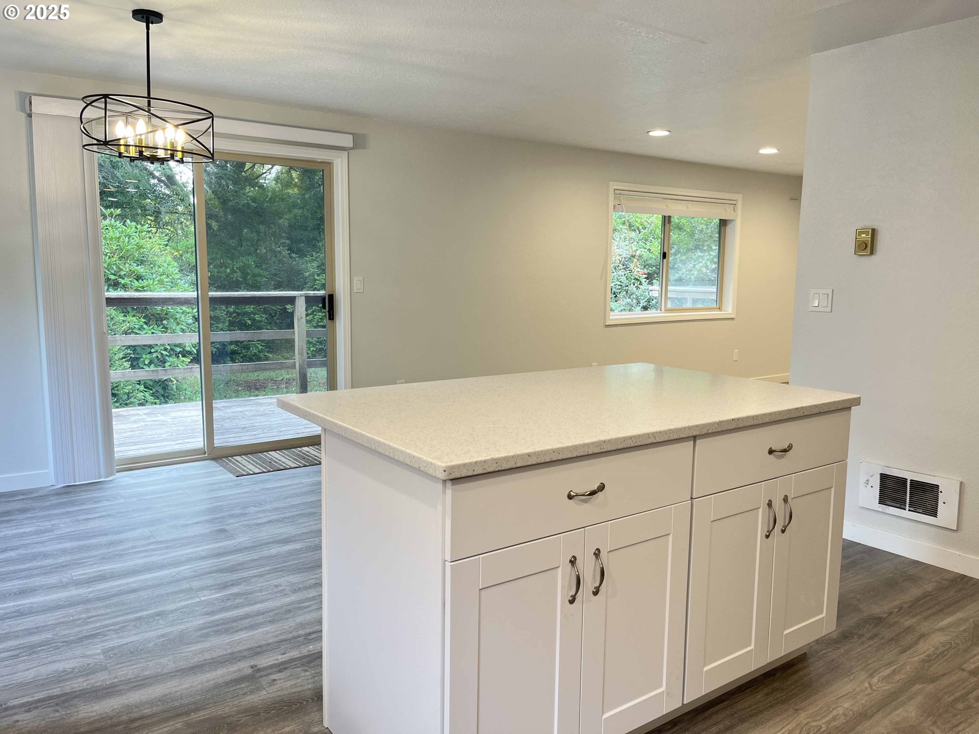 2040 11th Street Florence, OR 97439 - Photo 16 of 43 a view of a kitchen with a sink wooden floor and a window